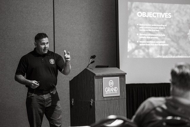 An instructor presenting to a class of firefighters
