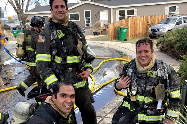 Firefighters in turnout gear on scene after a fire